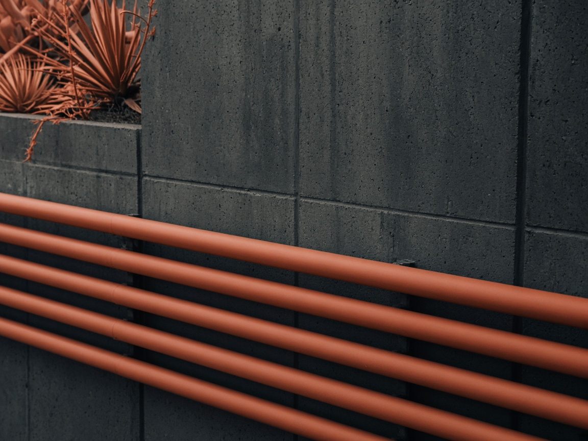 Terracotta pipe pathways on charcoal concrete